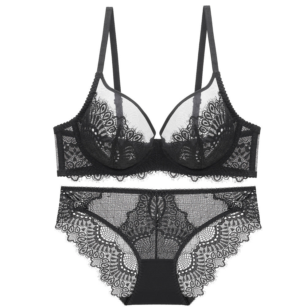 Elegant black floral lace bra and panty set laid flat on a white surface.
