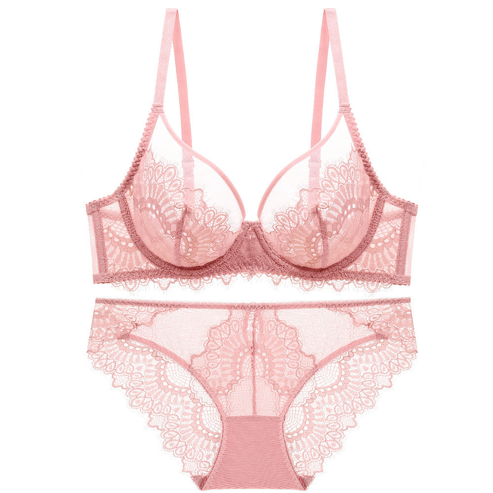 Blush pink lace bra and panty set displayed on a white surface.
